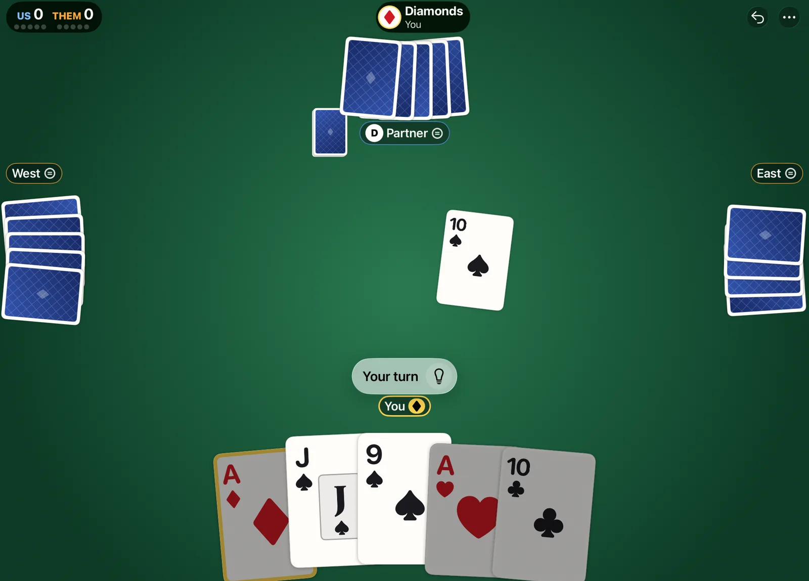 The table on a 13-inch iPad held sideways, diamonds trump. East has led the 10 of spades, and under a Your turn prompt the player's hand shows the jack and 9 of spades raised as the cards they may play.